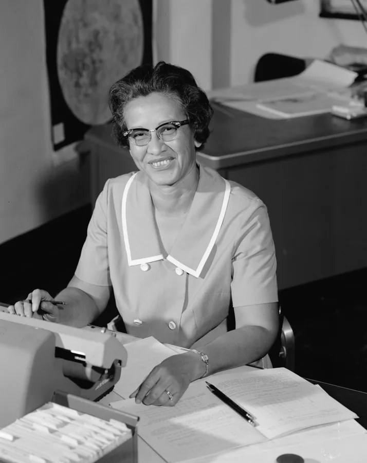 Katherine Johnson working at her desk with research papers